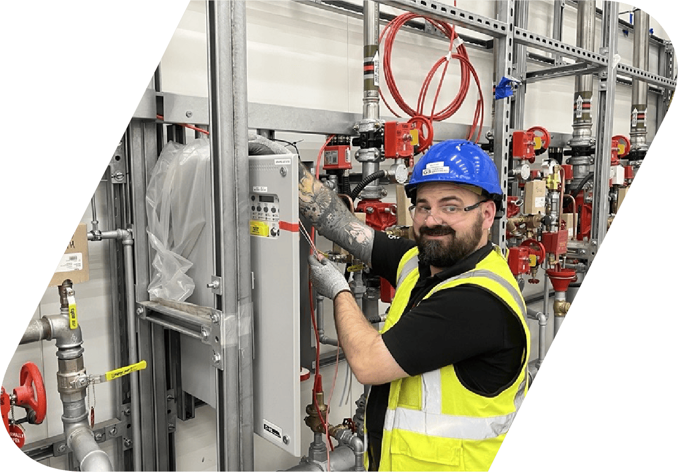 A safety engineer conducting an audit at a control panel.
