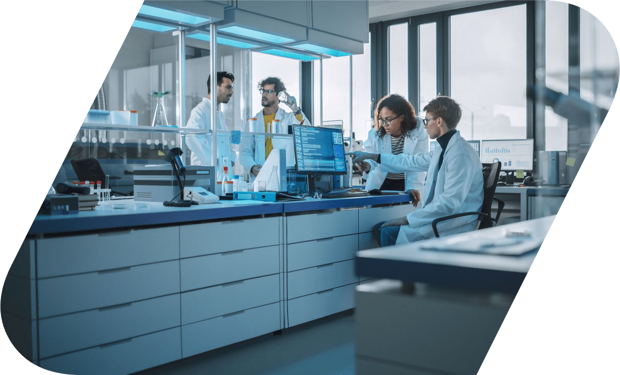 Scientists sitting in a lab in front of a computer.