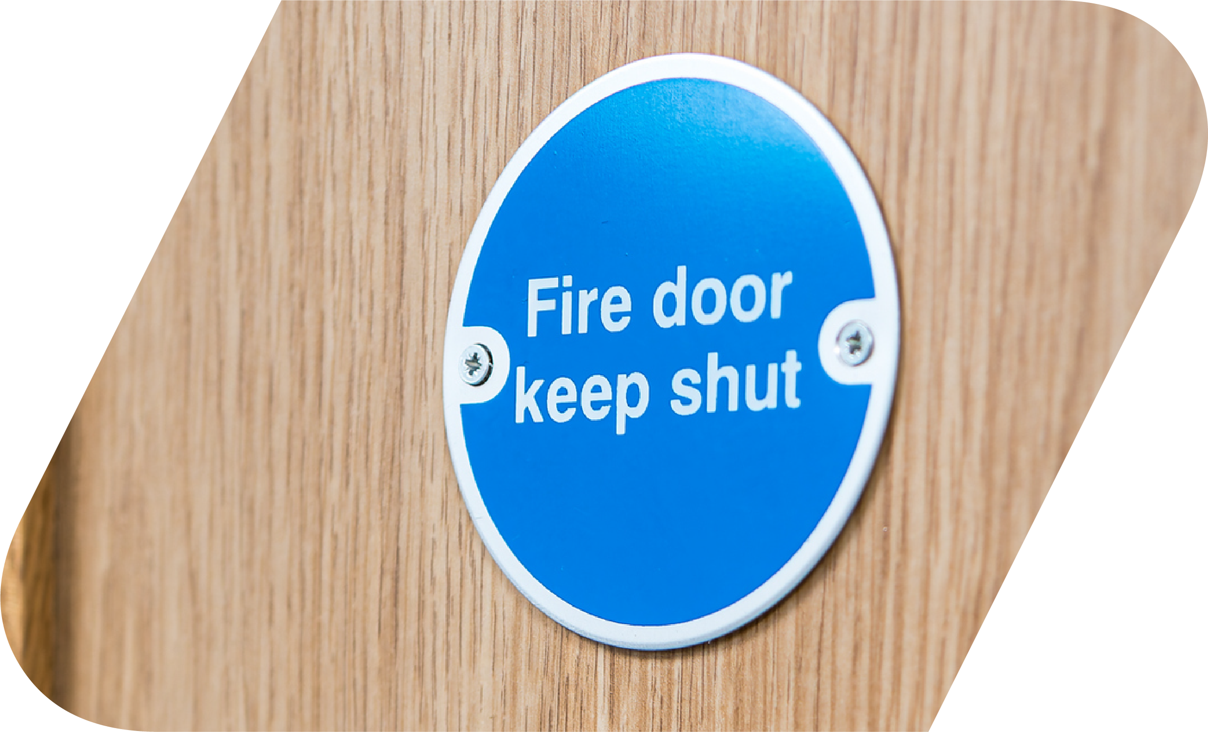 Fire door keep door shut sign against a wooden door.